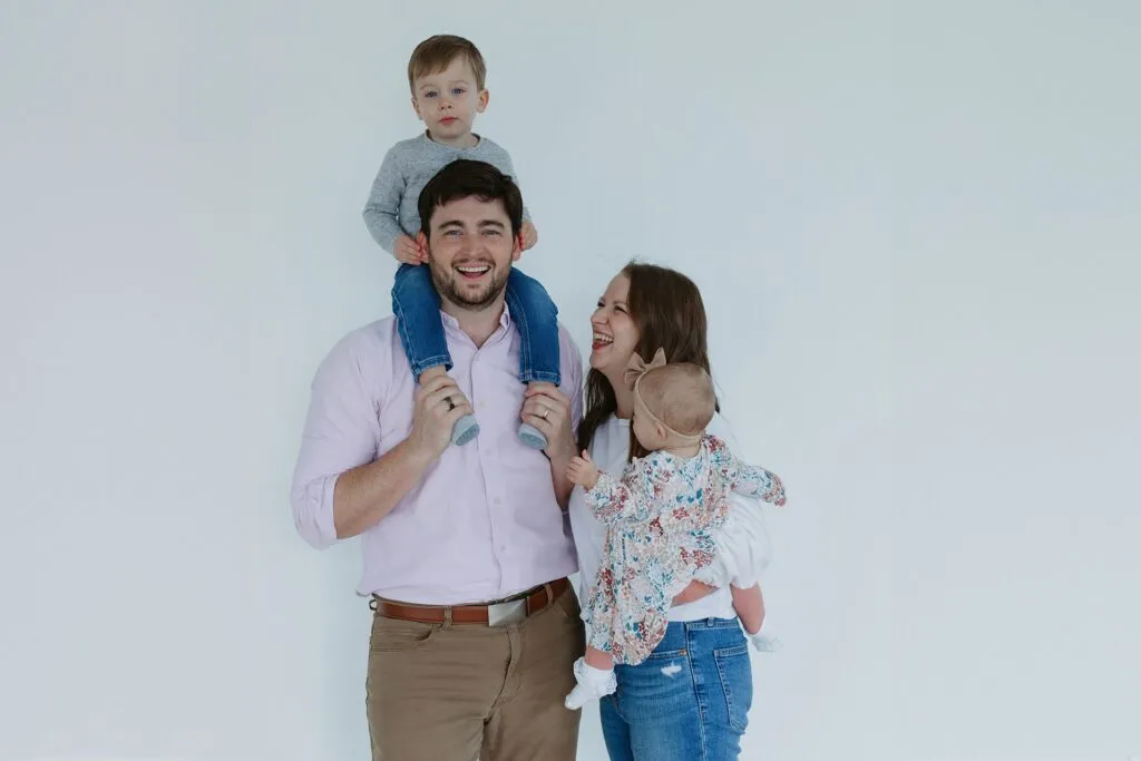 A heartwarming photo capturing a family's journey with braces at Razz Orthodontics, each member proudly revealing their transformed smiles.